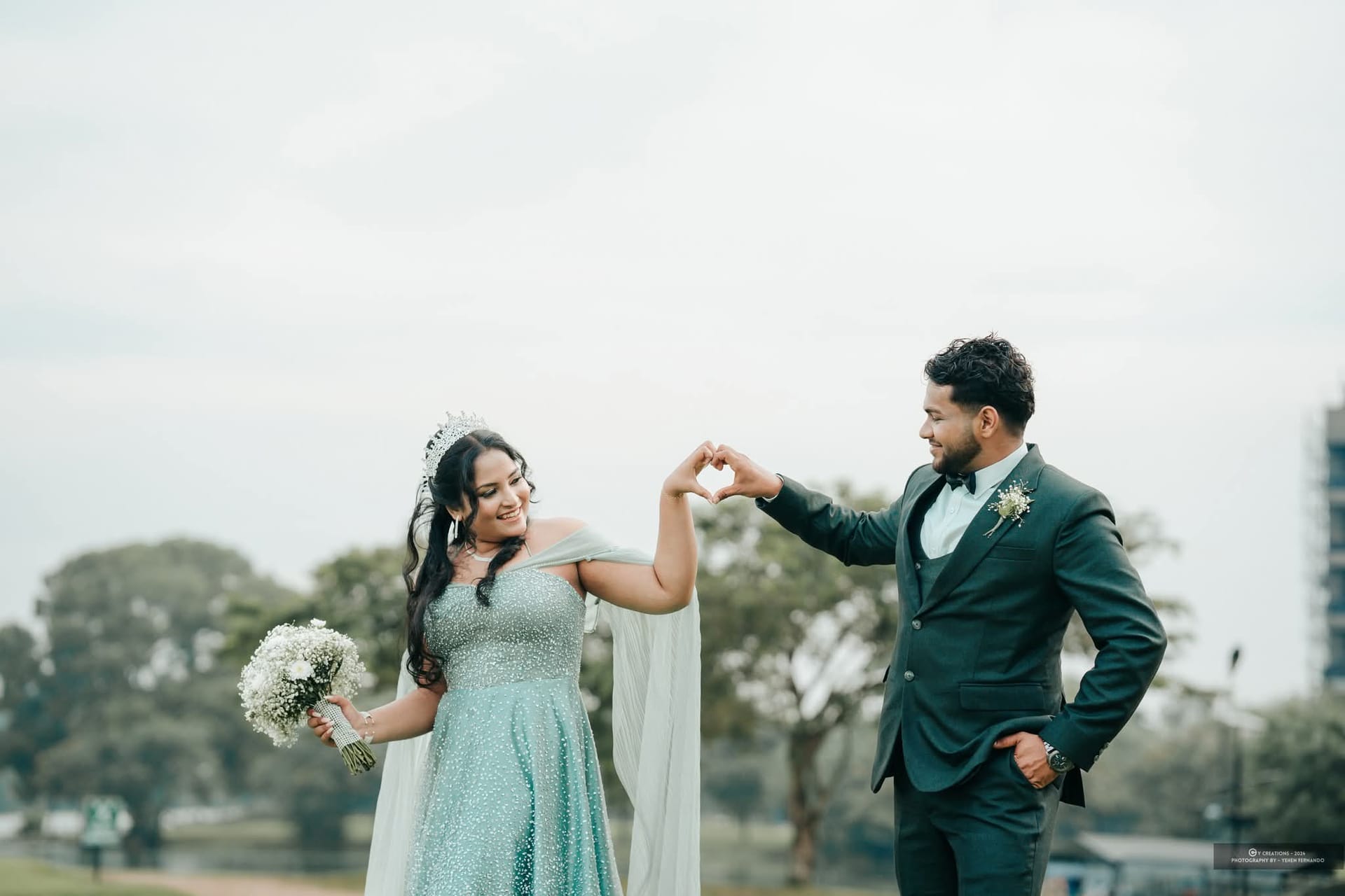 A bride and groom turning together on the lawn at their wedding